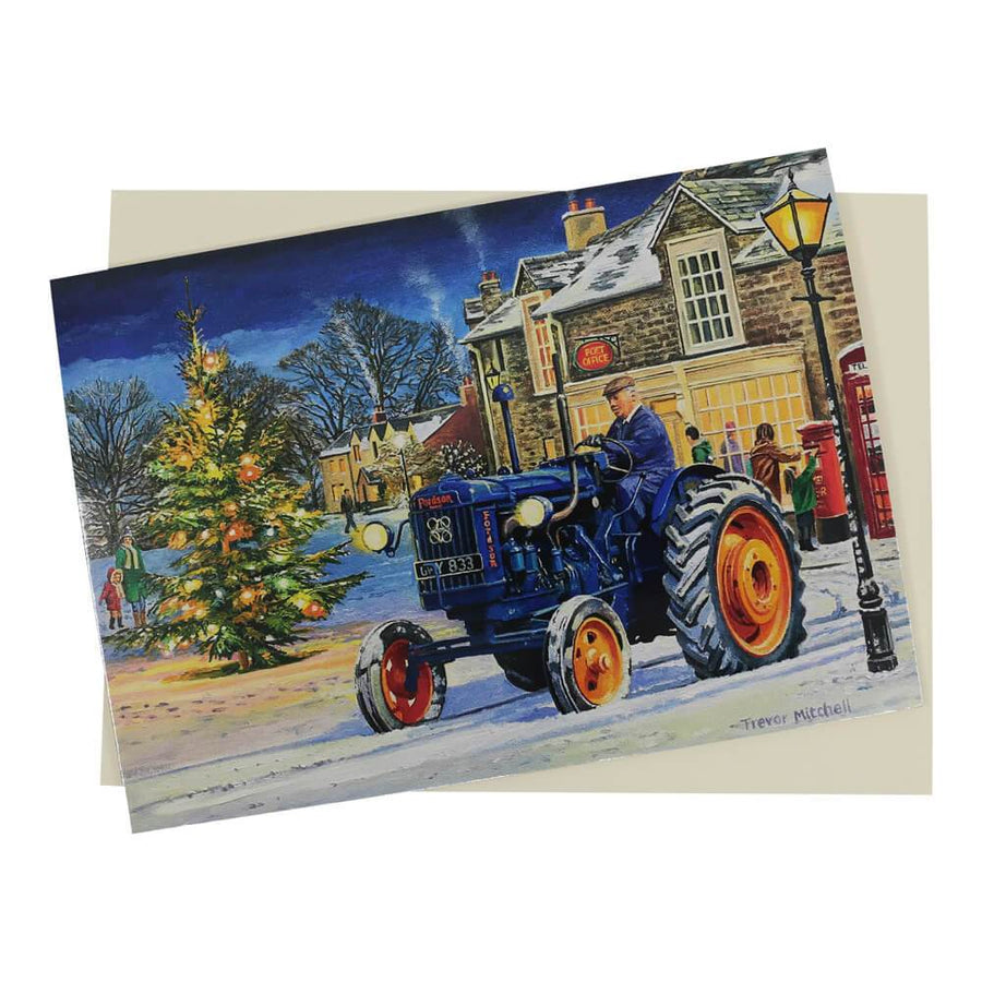 This period-style Fordson tractor Christmas card features a blue Major tractor in a night-time snow-covered village setting next to the village Christmas tree, all lit up.